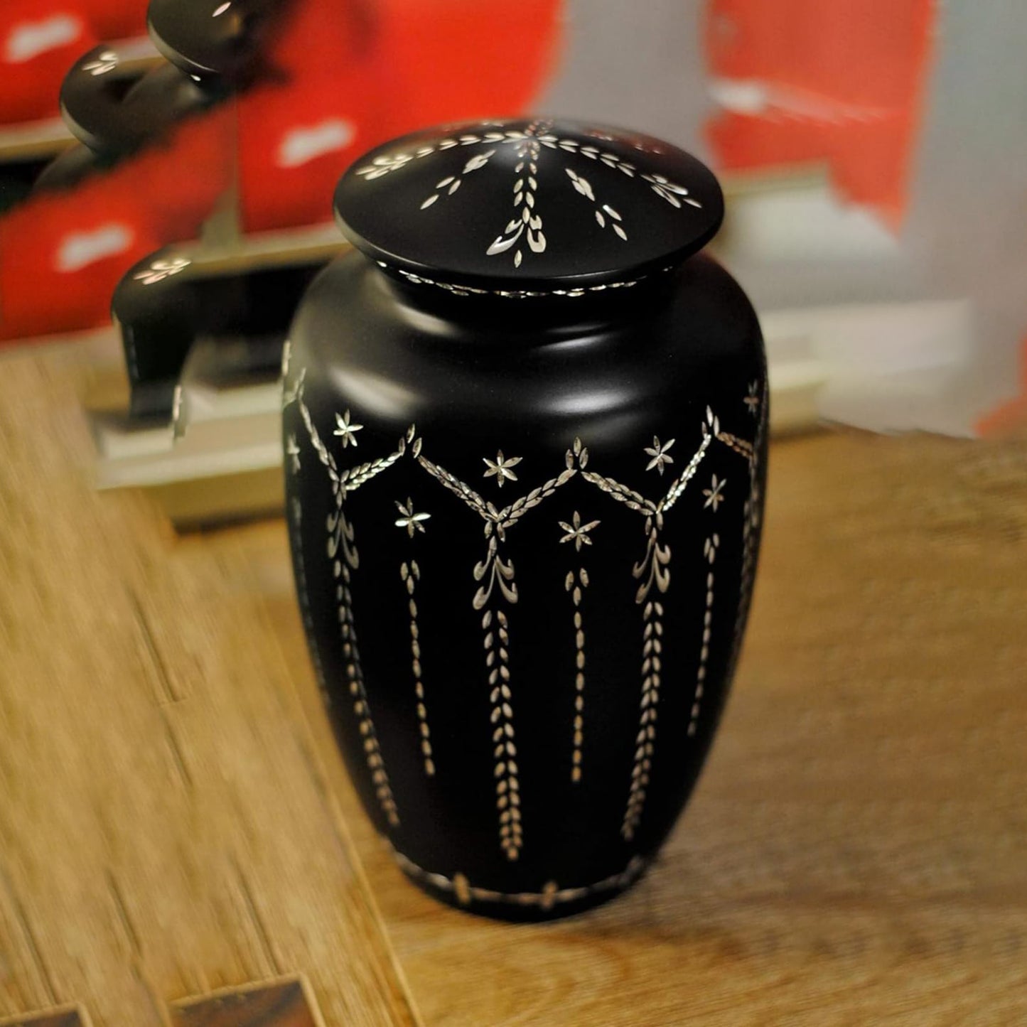 Black urn with decorative patterns