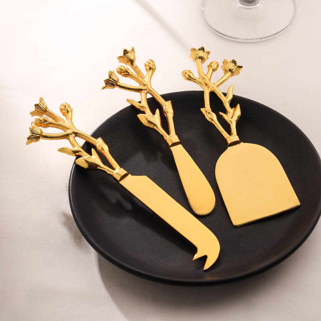 Gold cheese knives with branch design on a black plate - Eco-friendly - Sama Homes