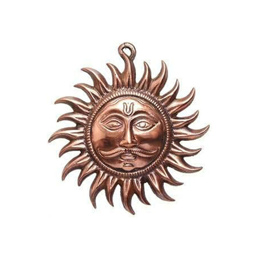 Copper sun-shaped pendant with face design on a white background