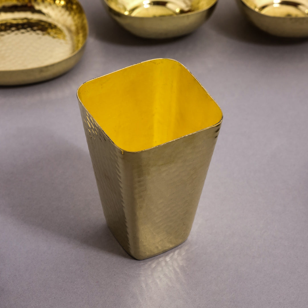 Gold metallic cup on a gray surface