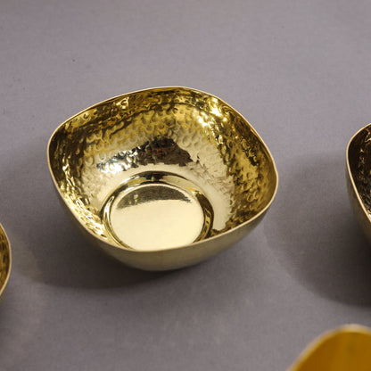 Gold bowl with a textured surface on a gray background