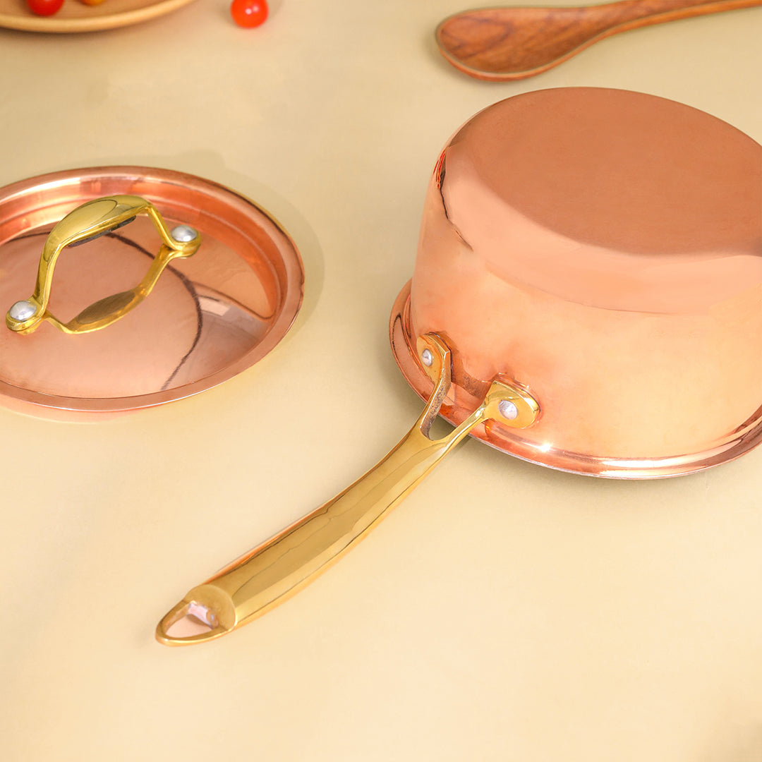 Copper saucepan with gold handle on a beige background - Image 5