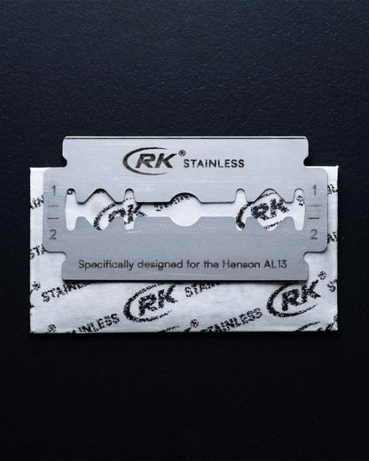 RK stainless steel razor blade on a black background