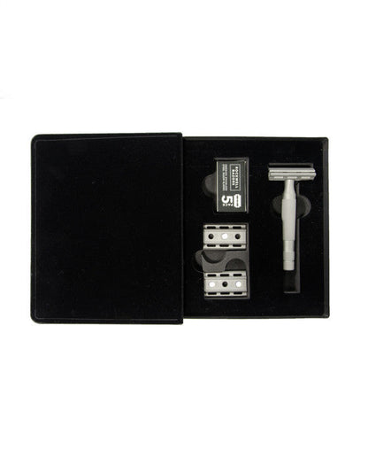 Shaving kit with razor and blades in a black case on a white background