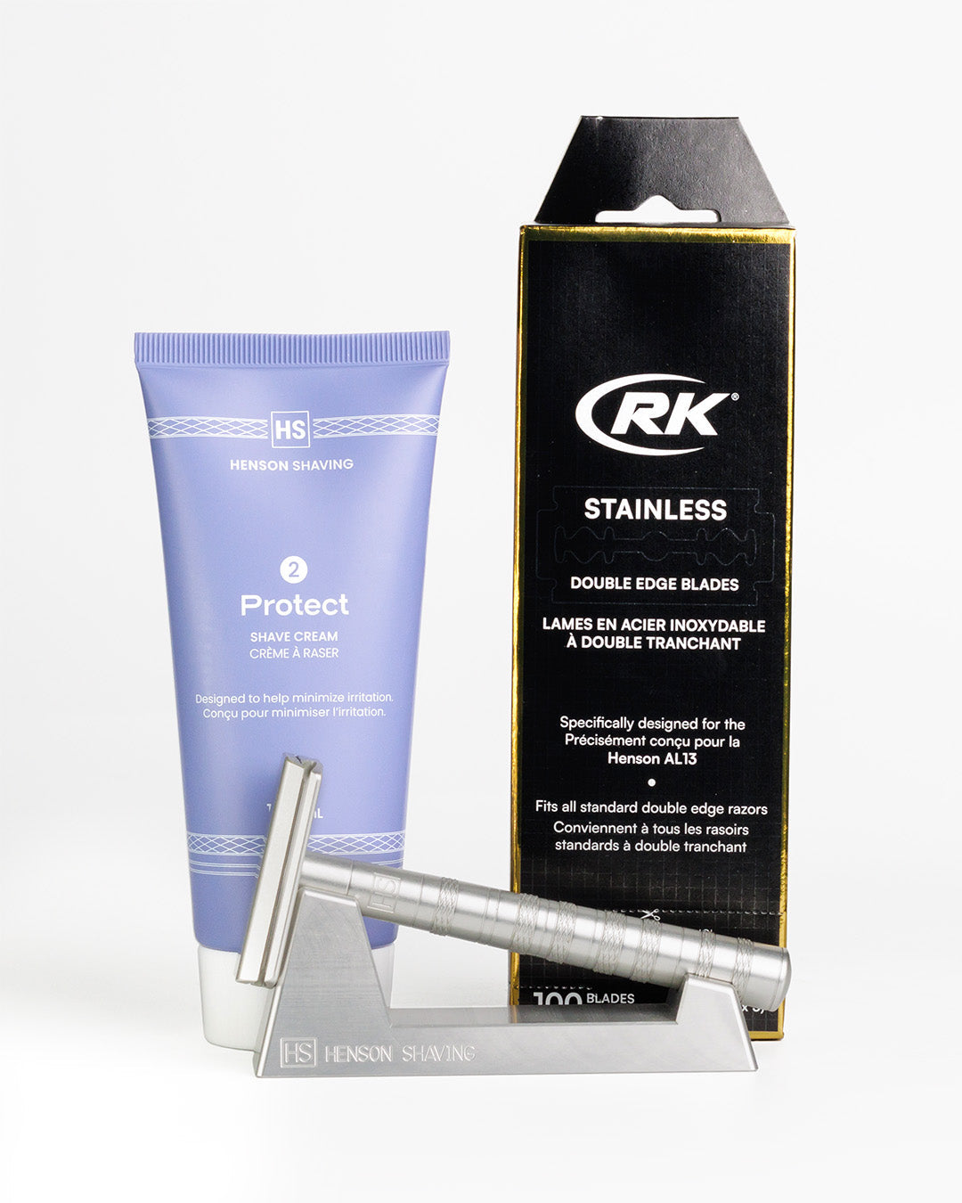 Shaving product set with a tube, razor, and packaging on a white background